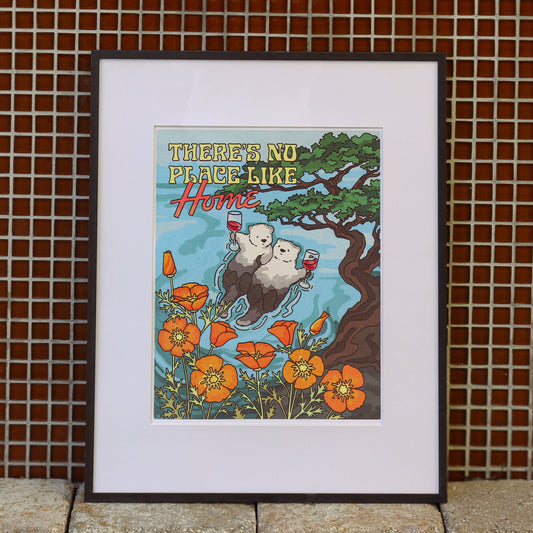 This image features an 11"x14" art print titled "No Place Like Home," displayed in a simple black frame. The artwork is vibrant and richly colored, printed using giclé-quality inks on heavyweight textured card stock that enhances the visual depth and durability of the piece.